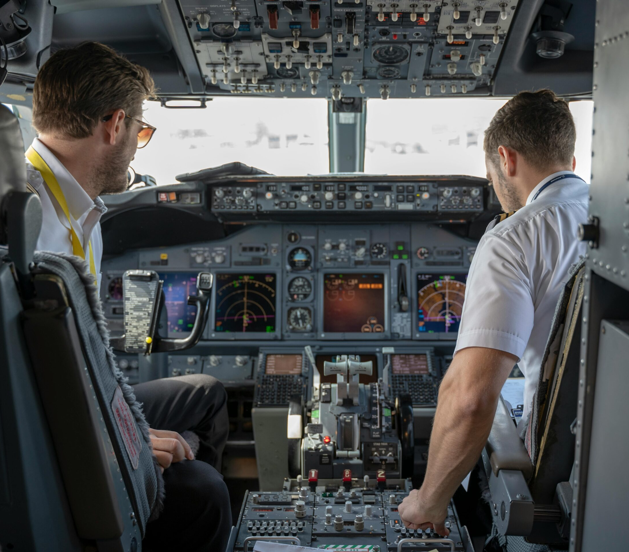 Two pilots seated in a commercial aircraft cockpit, symbolizing the responsibility and pressure faced by aviation professionals.